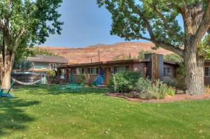 a house with a yard with a playground at Desert Gardens #3 in Moab