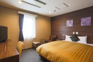 เตียงในห้องที่ Sun Royal Kawasaki