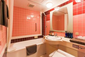 a bathroom with a sink and a tub and a toilet at Sun Royal Kawasaki in Kawasaki