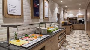 a buffet line in a restaurant with many plates of food at Holiday Inn Express - Wuppertal - Hauptbahnhof, an IHG Hotel in Wuppertal