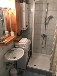 a bathroom with a sink and a shower and a toilet at BEA Active Studio near city center Tivoli Park in Ljubljana