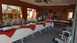 a long table with plates of food on it at Garden View Lodge in Mahikeng