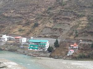 an aerial view of a building next to the water at Prakriti-The Retreat in Gangotri