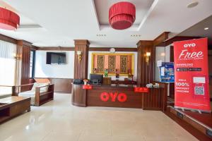 a lobby of a hotel with a one free sign at OYO 389 Sira Boutique Residence in Patong Beach