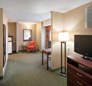 a hotel room with a television and a living room at Holiday Inn Express Red Deer, an IHG Hotel in Red Deer