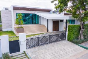 a house with a black and white fence at Mövenpick Luxury Villa2FL-Private Pool-SHA CERTIFIED in Na Jomtien