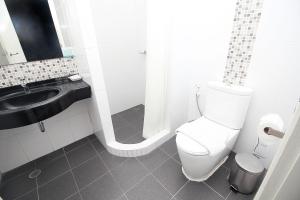 a bathroom with a toilet and a sink at Simplitel in Karon Beach