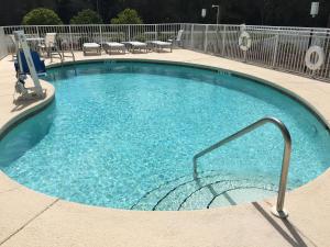 a large swimming pool with blue water in a building at Holiday Inn Express DeFuniak Springs, an IHG Hotel in DeFuniak Springs