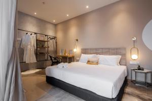 a bedroom with a large white bed in a room at One Heritage Hotel in Seremban