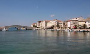 a bridge over a body of water with buildings at Apartment Doder in Pag