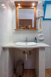 a bathroom with a sink and a mirror at Olympia Mare in Kardamaina