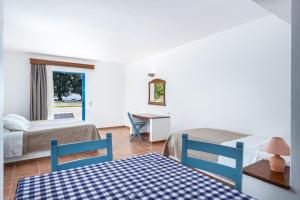 a room with a bed, table and chairs at Olympia Mare in Kardamaina