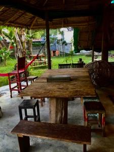 a wooden table and benches in a pavilion at Lazy Bones in Koh Rong Sanloem
