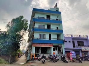 a blue building with motorcycles parked in front of it at ARJUN GUEST HOUSE in Pathānkot