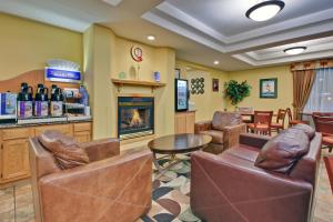 a waiting room with leather chairs and a fireplace at Holiday Inn Express Dryden, an IHG Hotel in Dryden