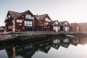 a row of houses next to a body of water at Björholmen Hotell & Restaurang in Björholmen +51 photos