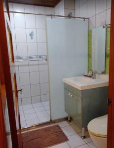 a bathroom with a shower and a sink and a toilet at Kamiyamato B&B in Guangfu