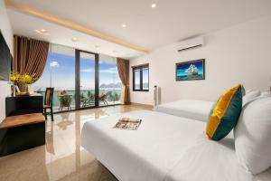 a hotel room with two beds and a balcony at Tuan Chau Kingly Villa in Ha Long