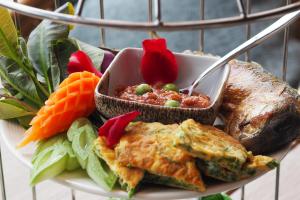 a plate of food with a bowl of food and vegetables at Eleven Bangkok Sukhumvit 11 by Kingston Hotels in Bangkok +111 photos