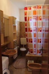 a bathroom with a toilet and a shower curtain at Apartments Đurđa - close to the sea in Pirovac