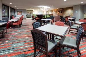 a dining room with tables and chairs at Holiday Inn Express & Suites Bloomington West, an IHG Hotel in Bloomington