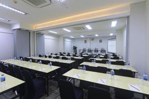 a large room with tables and chairs with water bottles on them at Cordela Inn Bengkulu in Bengkulu