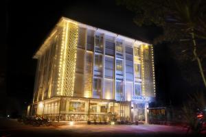 a large building with lights on it at night at Cordela Inn Bengkulu in Bengkulu