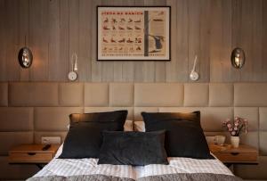 a bedroom with a bed with two night stands and a poster at Apart-Center Przy Krupówkach in Zakopane
