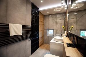 a bathroom with a sink and a toilet in it at Apart-Center Przy Krupówkach in Zakopane +87 photos