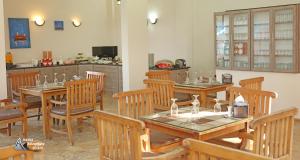 a dining room with wooden tables and chairs at Aqaba Adventure Divers Resort & Dive Center in Aqaba