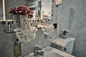 a bathroom with a sink and a mirror at Hotel Victoria in Taormina