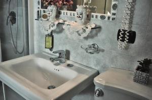 a bathroom with a sink and a toilet at Hotel Victoria in Taormina
