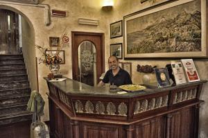 a man sitting at a bar in a room at Hotel Victoria in Taormina