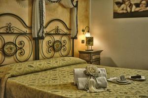 a bedroom with a large bed with a large headboard at Hotel Victoria in Taormina