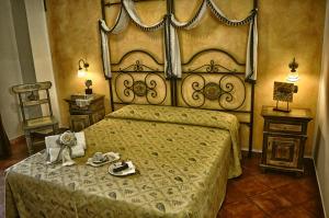 a bedroom with a large bed with shoes on it at Hotel Victoria in Taormina