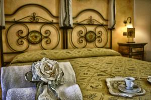 a bedroom with a large bed with a flower on it at Hotel Victoria in Taormina