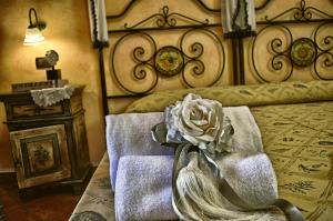 a bedroom with a bed with a flower on it at Hotel Victoria in Taormina