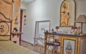 a bedroom with a desk and a mirror and a bed at Hotel Victoria in Taormina