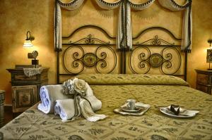 a bedroom with a large bed with towels and dishes on it at Hotel Victoria in Taormina