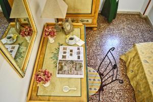an overhead view of a room with a table with a book and flowers at Hotel Victoria in Taormina