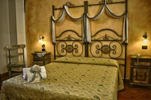 a bedroom with a large bed with a large headboard at Hotel Victoria in Taormina
