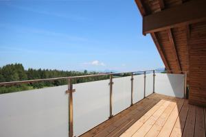 a balcony of a house with a wooden deck at Zugspitz-Chalet in Oy-Mittelberg +6 photos