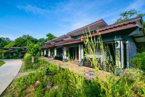 a house with a garden in front of it at Loft Vintage Chalet resort in Ko Lanta