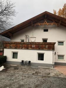 a white building with a wooden roof at Haus Oberdorf in Zams