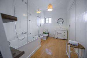 a bathroom with a tub and a toilet and a sink at Casa das Hortênsias - Charming Guest House in Sintra +123 photos