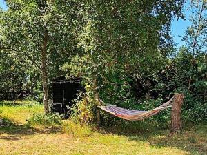 a hammock hanging from a tree in a yard at 5 person holiday home in V ggerl se in Marielyst