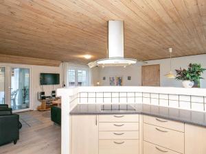 Øbyにある10 person holiday home in Ulfborgの木製の天井のキッチン、リビングルームが備わります。