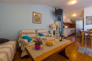 a living room with a couch and a table at Kruzic app in Crikvenica