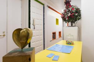 a yellow table with a heart statue on top of it at Soul City in Naples