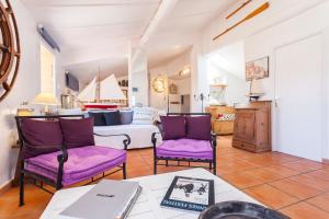 a living room with purple chairs and a table at Appartements Vieux Nice / Marché aux fleurs in Nice